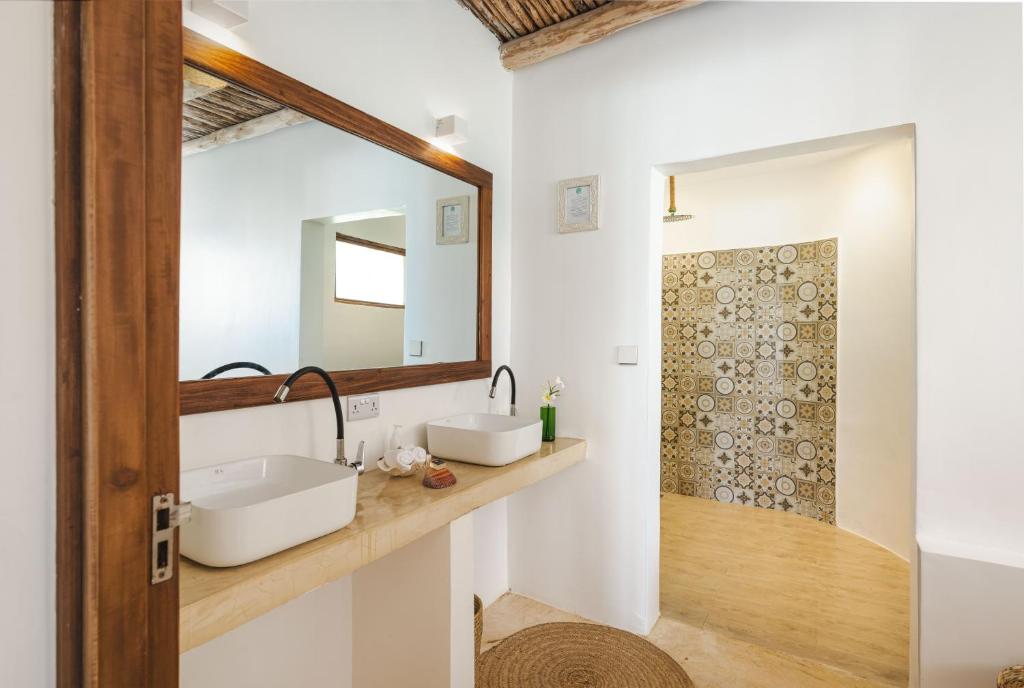 Zanbluu Beach viesnīcas elegantā vannas istaba ar diviem izlietnēm.