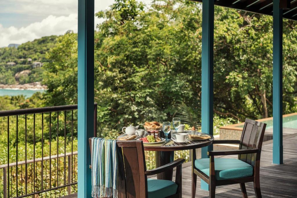 Privātas brokastis uz terases Four Seasons Resort Seychelles ar skatu uz tropu dārzu.
