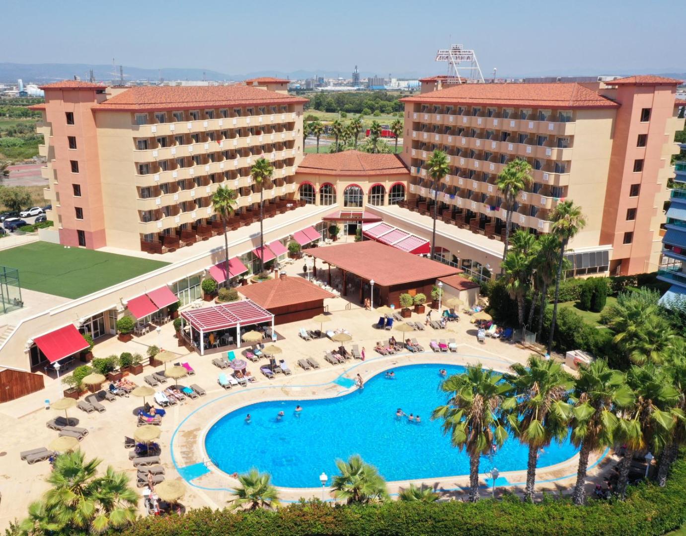 Ohtels La Hacienda skats no augšas uz plašo āra baseinu, sauļošanās zonu un viesnīcas korpusiem La Pinedā, Spānijā