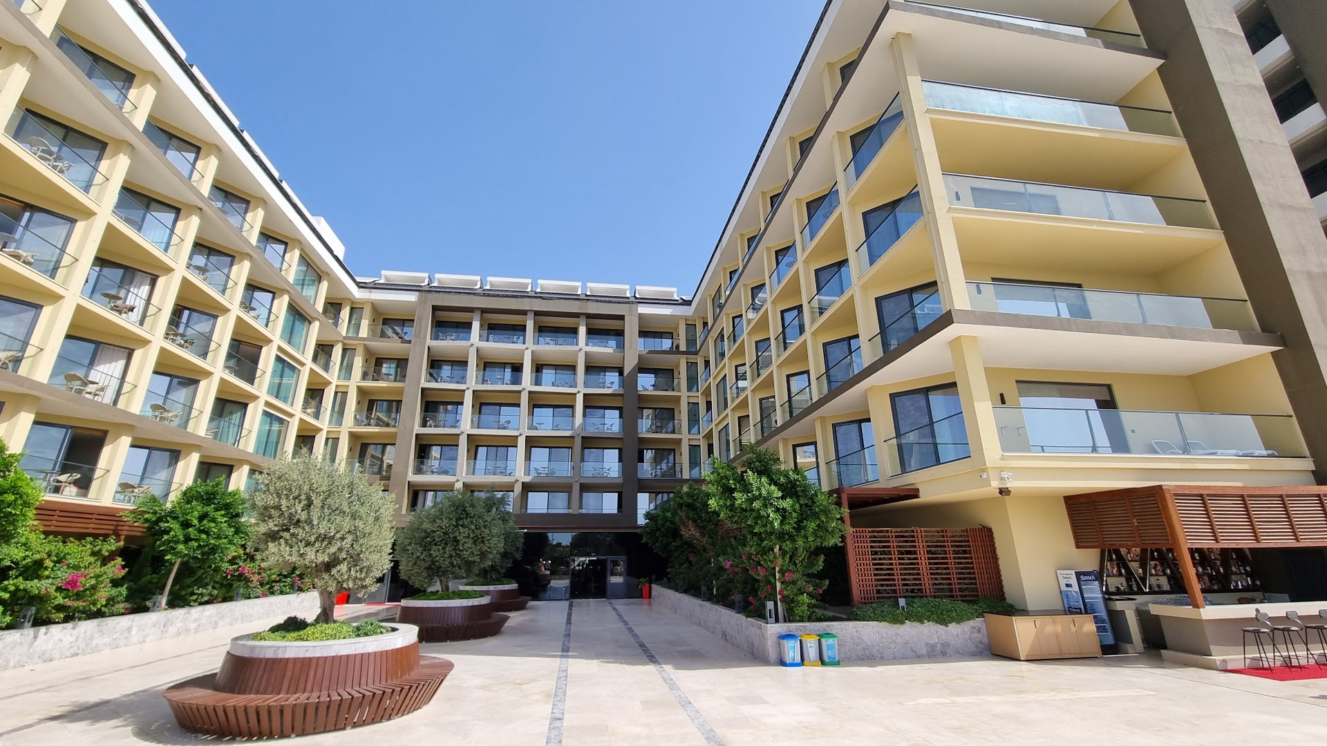 Sorgun Akadia Hotel Luxury ēkas fasāde ar balkoniem, olīvkokiem un āra bāru dienas laikā Turcijā