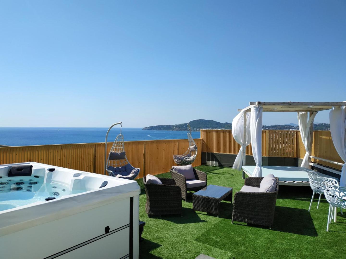 Pegasos Beach Hotel jumta atpūtas zona ar džakuzi, zviļņiem un mīkstajiem krēsliem Rodas salā — panorāmas skats uz līci