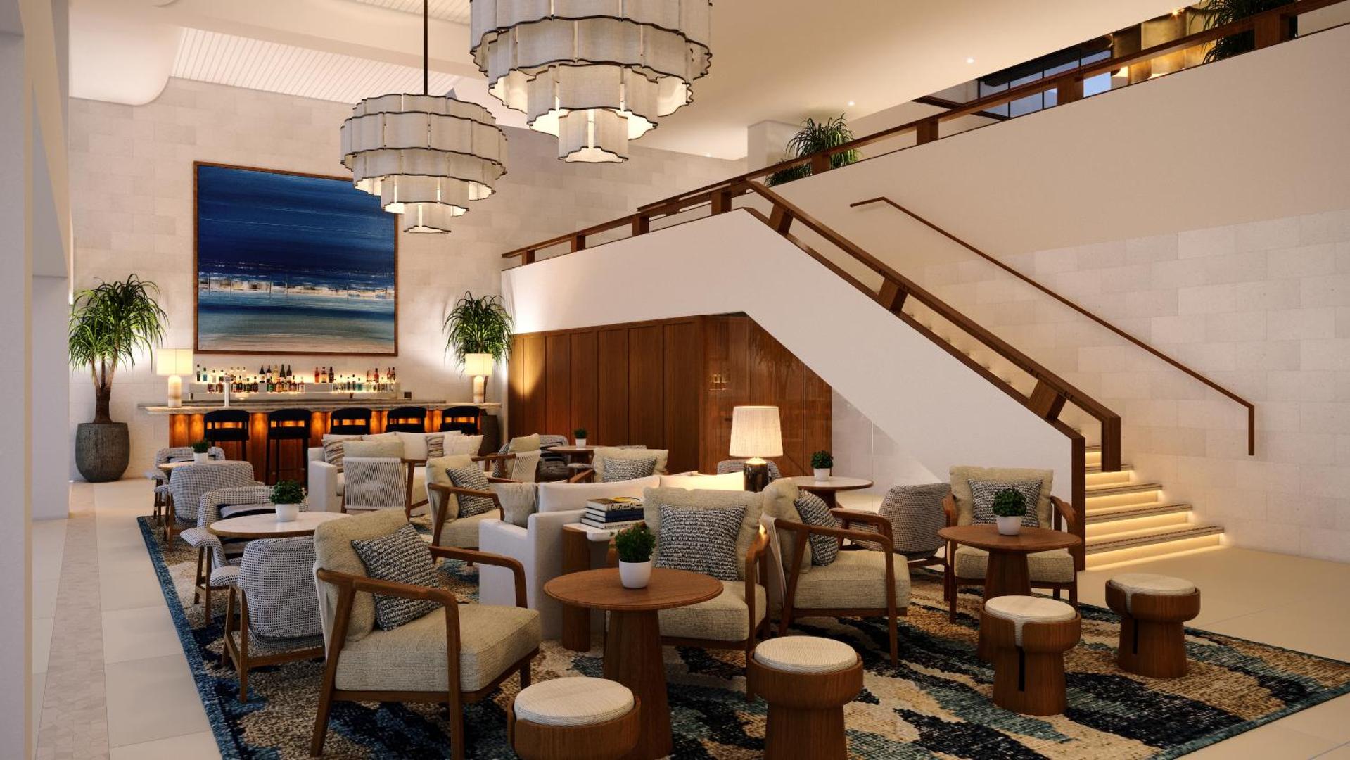 Porto Elounda Golf & Spa Resort lobby bārs ar bāra leti, kāpnēm un ērtām atpūtas zonām viesnīcas galvenajā ēkā