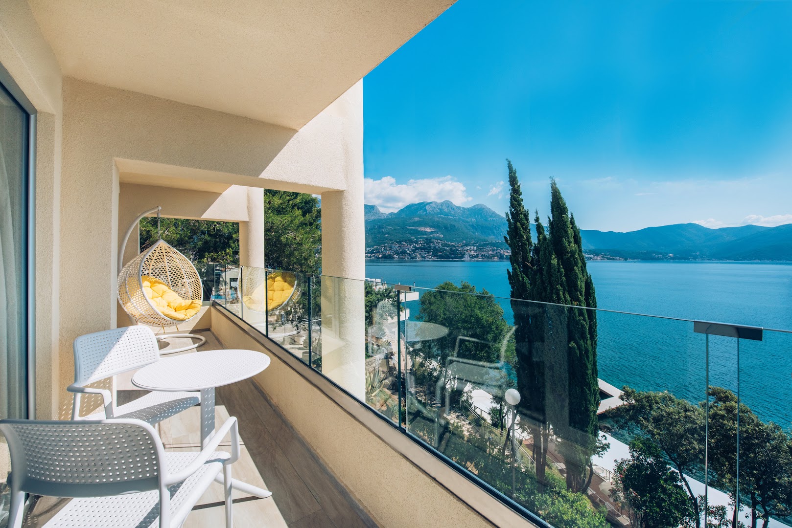 Iberostar Herceg Novi numura balkons ar iekaramo krēslu, galdiņu un panorāmas skatu uz Kotoras līci un kalniem Melnkalnē