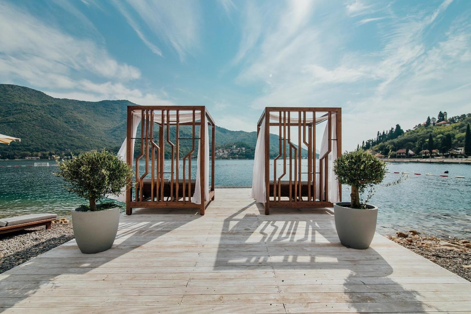 Koka atpūtas platforma virs ūdens ar divām nojumes gultām Boutique Hotel & Spa Casa del Mare viesnīcā Melnkalnes piekrastē