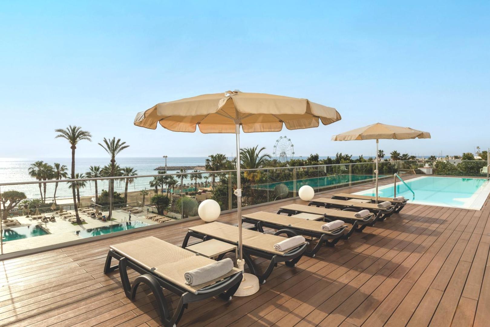 Ocean House Costa del Sol jumta terase ar sauļošanās krēsliem, saulessargiem un nelielu baseinu ar skatu uz jūru