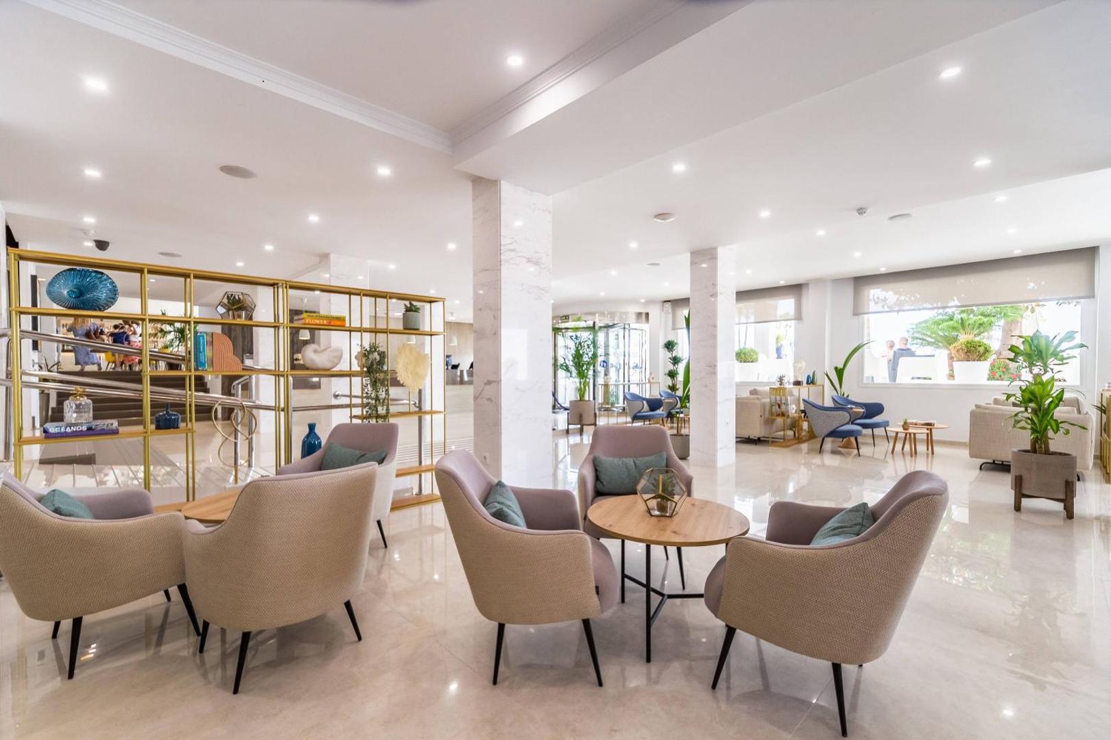 Plašs un gaišs Las Arenas affiliated by Melia viesnīcas vestibils ar marmora grīdām, moderniem atpūtas krēsliem un lieliem logiem