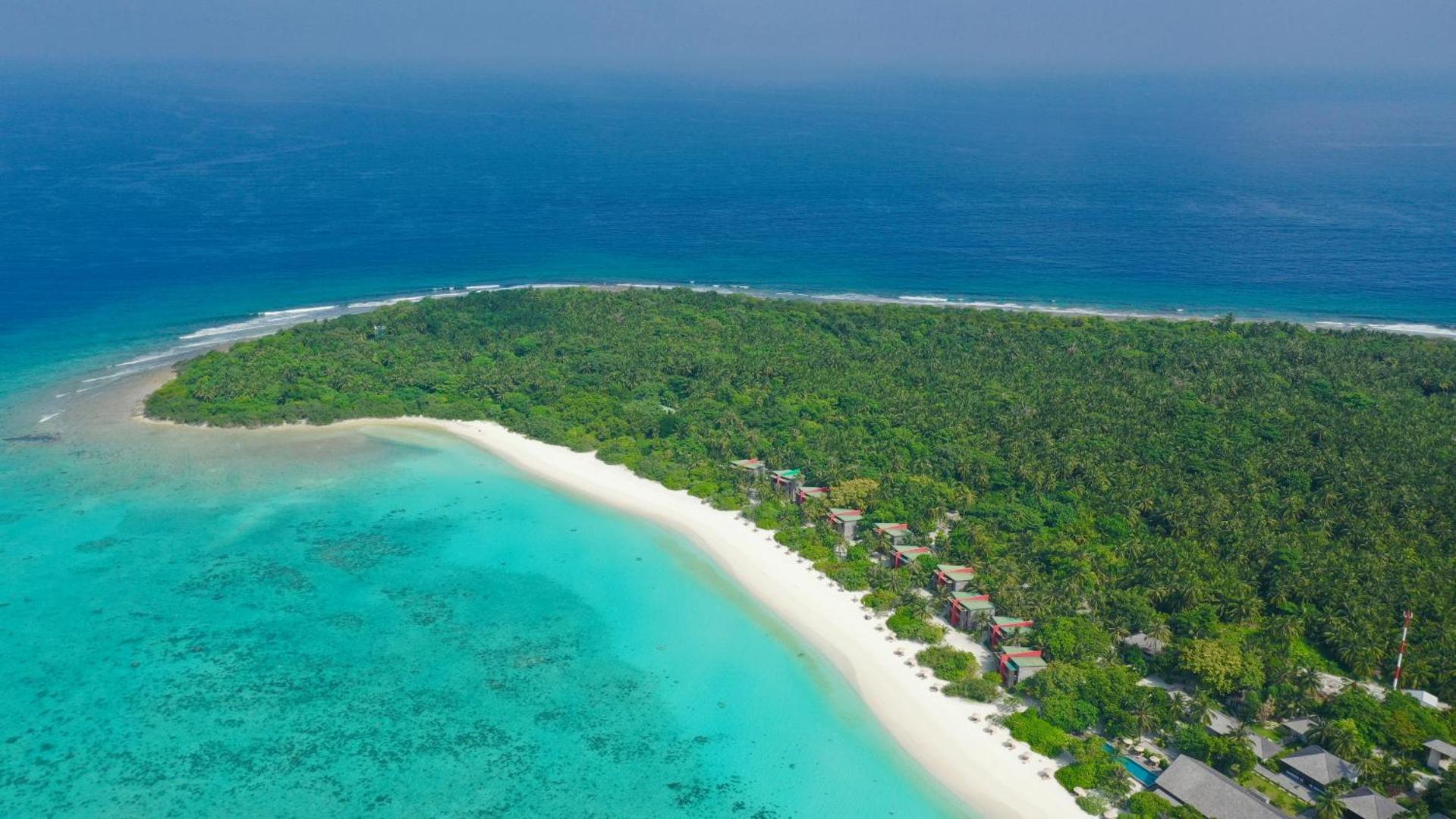 The Barefoot Eco Hotel panorāmas skats no putna lidojuma uz tropu salu, balto smilšu pludmali un tirkīzzilo okeānu Maldivu salās