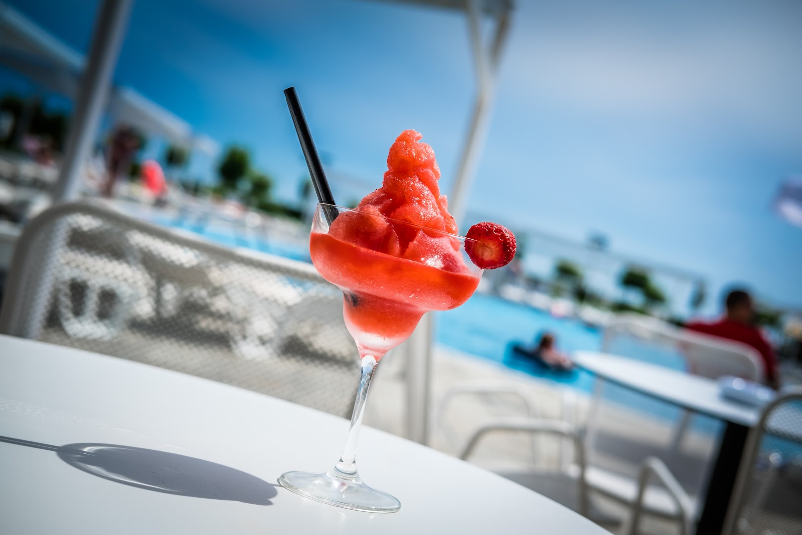 Saldēts zemeņu kokteilis uz galda pie Premier Fort Beach Hotel baseina saulainā dienā Sveti Vlasas kūrortā