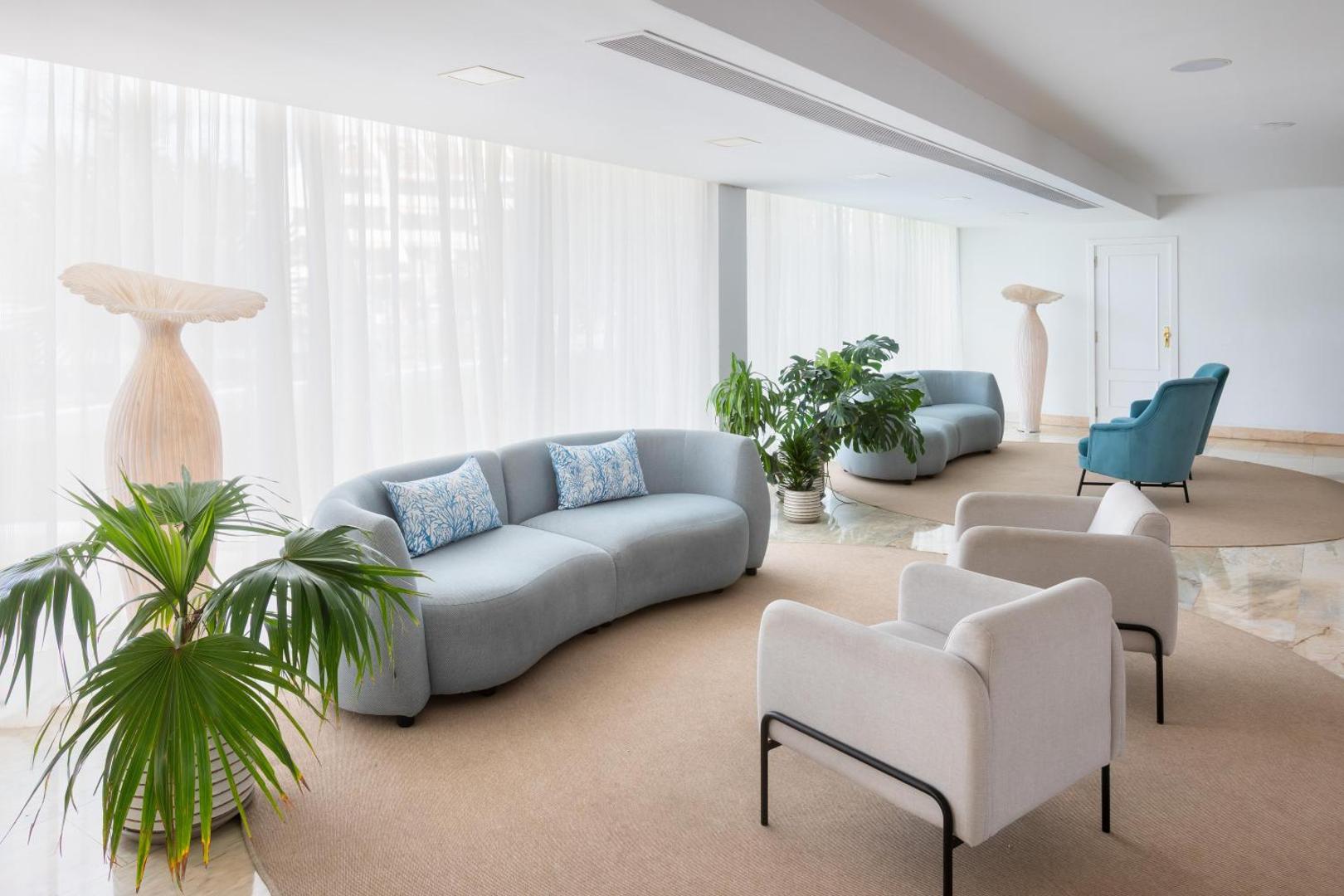 Alexandre Hotel La Siesta atpūtas zona vestibilā ar mīkstiem dīvāniem, krēsliem un telpaugiem gaišā un mājīgā atmosfērā