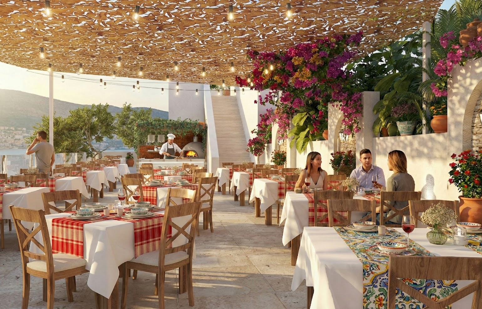 Baska Resort Bodrum āra terases restorāns ar ziedošām bugenvillijām, klātiem galdiem un skatu uz jūru saules gaismā