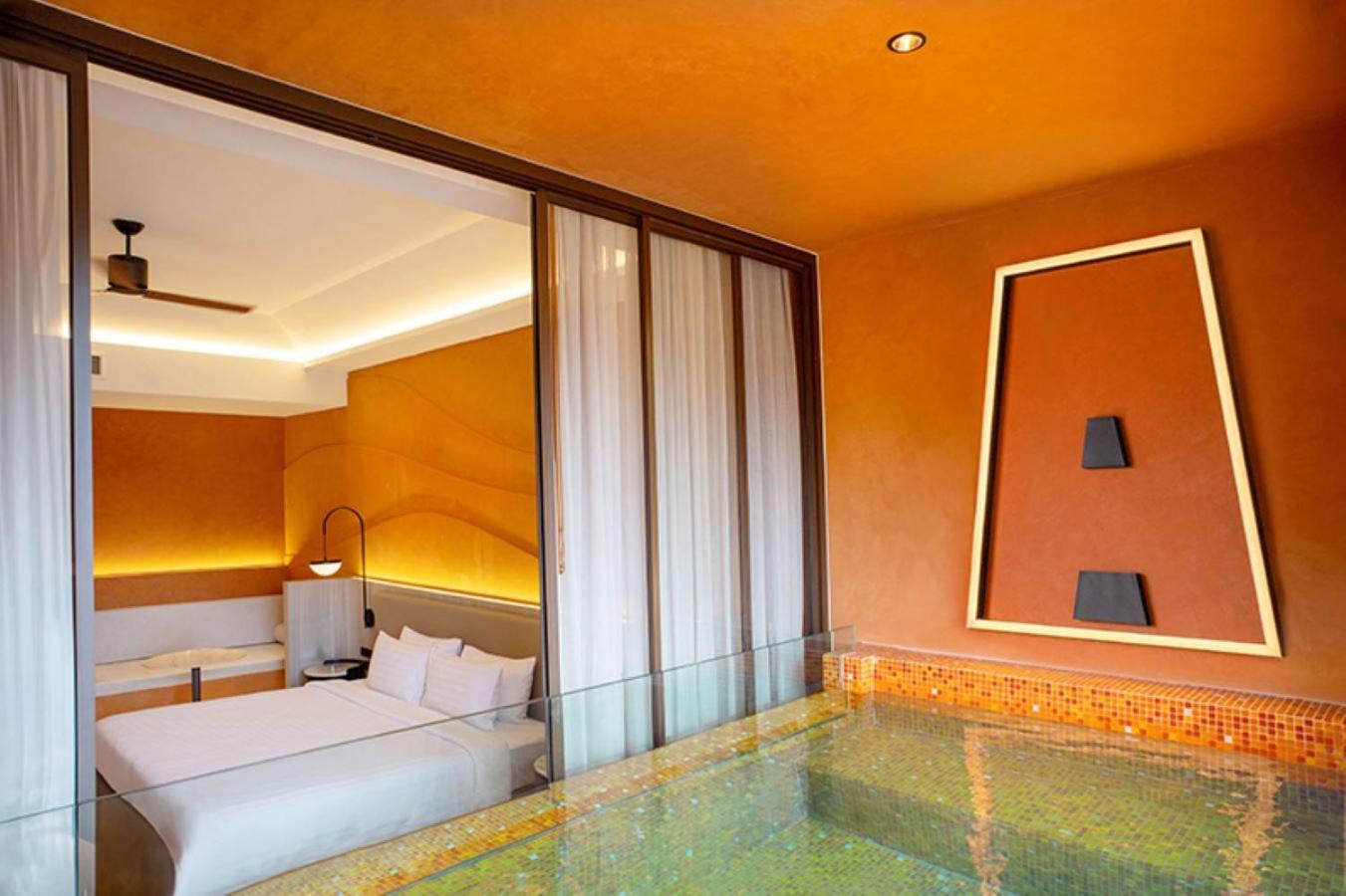 Hotel Adam Krabi moderns numurs ar tiešu piekļuvi privātam baseinam — gaišs interjers, liela gulta un stikla sienas