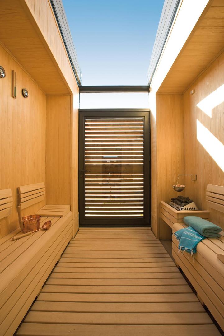 Lykia World Antalya moderna sauna ar koka apdari un stikla griestiem, kas ļauj ieplūst dabiskajai gaismai.