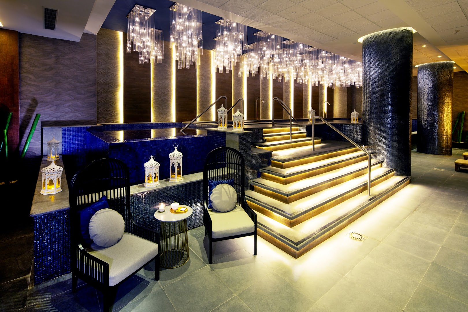 Royalton CHIC Cancun spa centrs ar iekštelpu baseinu, dekoratīvām laternām un mirdzošām lustrām relaksācijai