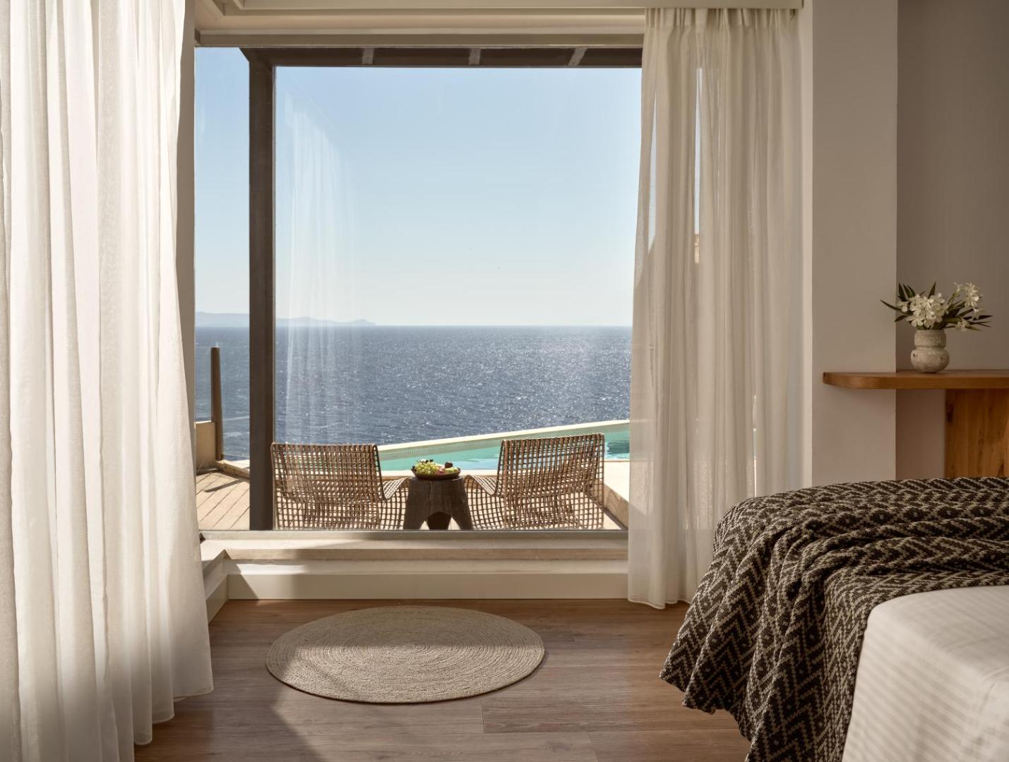 Seaside A Lifestyle Resort numura interjers ar skatu uz privāto baseinu un jūru caur lielu logu