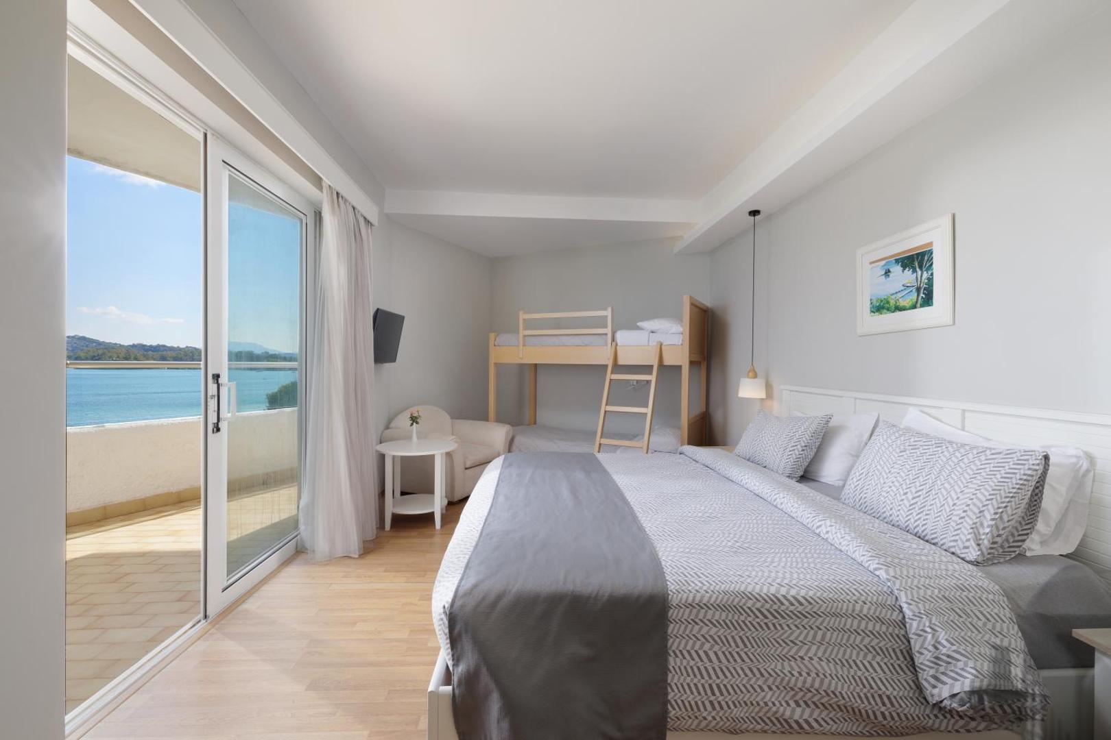 Elea Beach Hotel ģimenes numurs ar divstāvu gultu bērniem un lielu balkonu ar skatu uz jūru Korfu piekrastē
