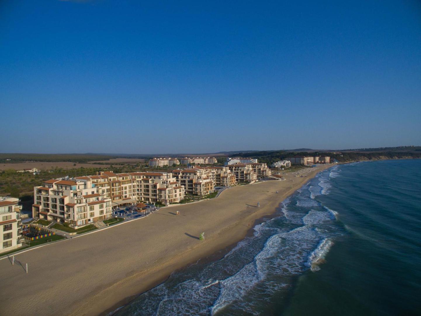 Obzor Beach Resort panorāmas skats uz plašo smilšu pludmali un Melno jūru Obzorā — kūrorta ēkas piekrastes pirmajā līnijā