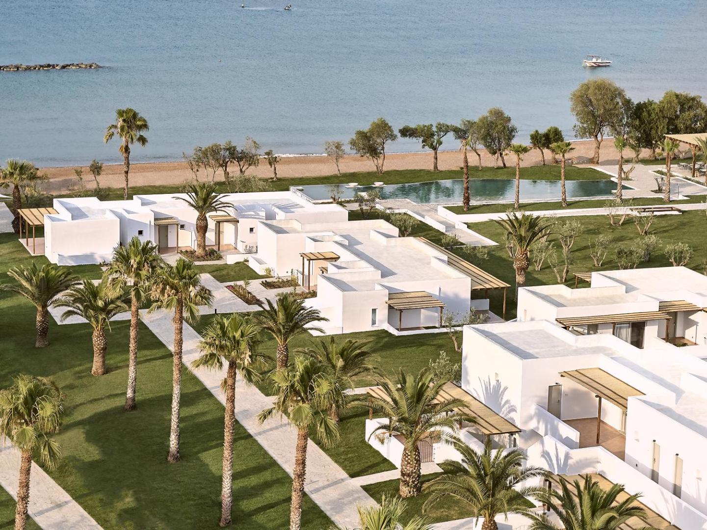 Grecotel Casa Marron baltie bungalo numuri un kopti zālāji ar palmām blakus baseinam un jūras krastam