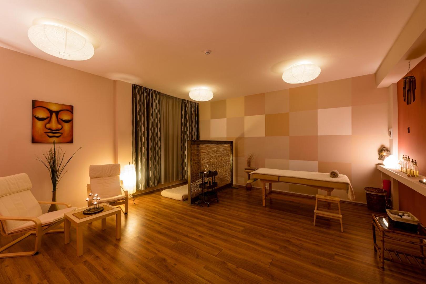 Pavlina Beach spa centrs ar masāžas galdu, atpūtas krēsliem un siltu apgaismojumu relaksējošā atmosfērā Peloponēsas reģionā.
