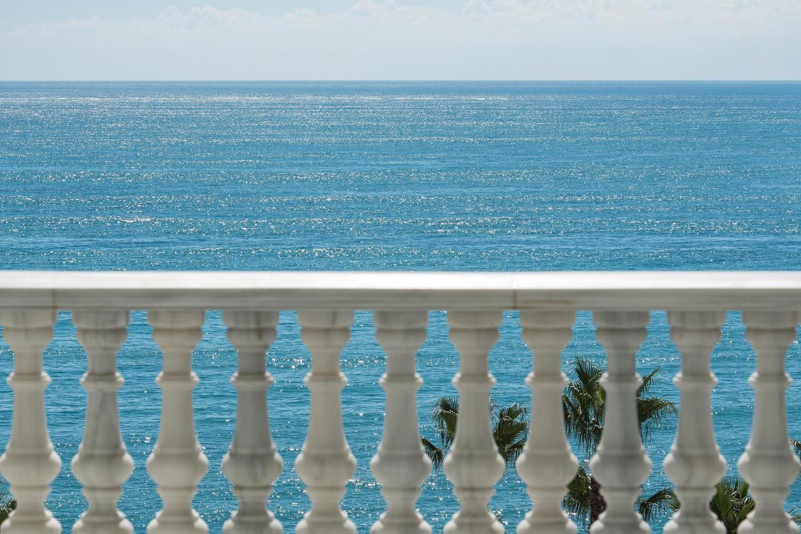 Skats uz dzidri zilo Vidusjūru no Gran Hotel Miramar balkona ar klasiskām baltām margām Malagā