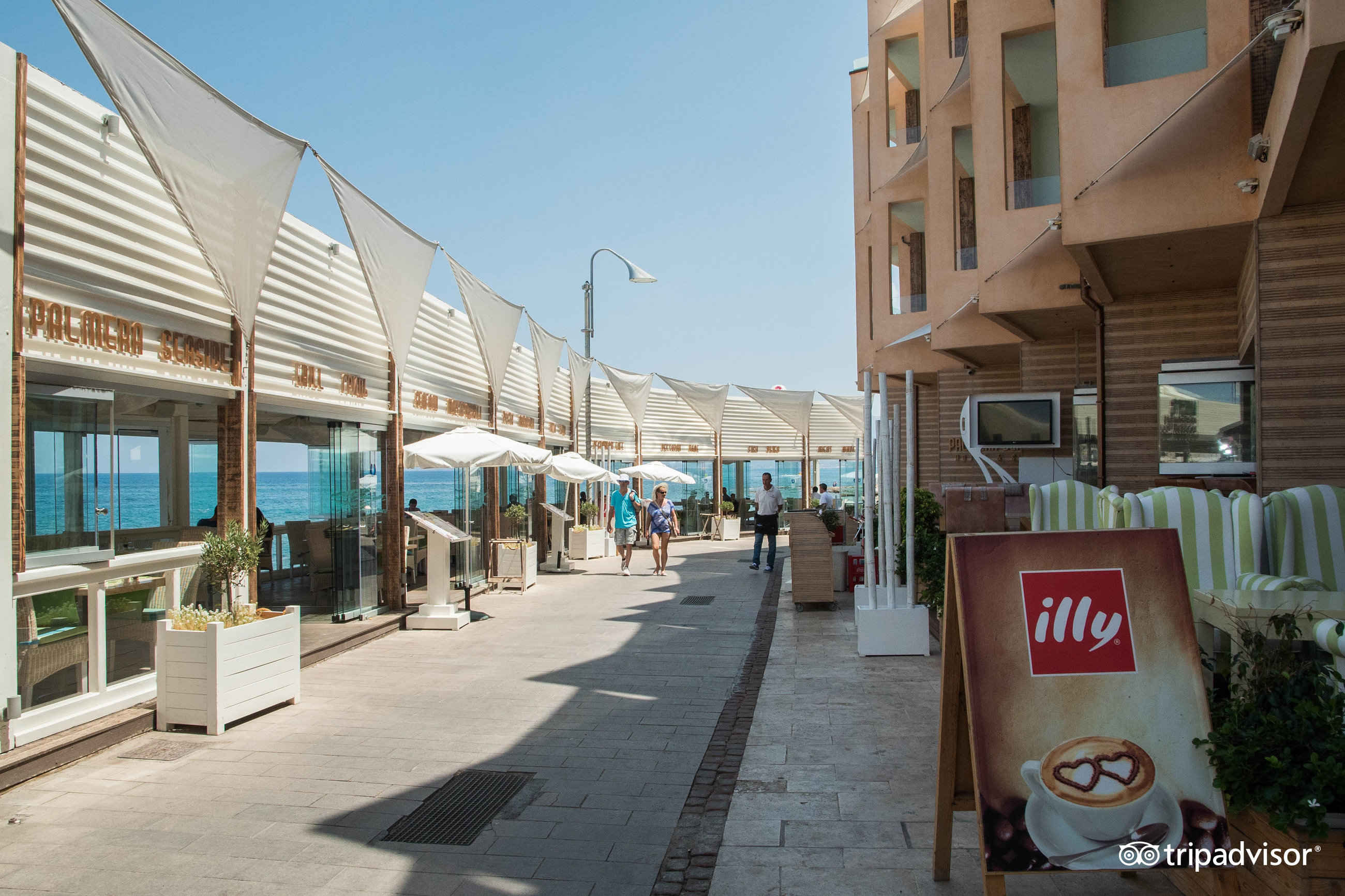 Palmera Beach Hotel & Spa promenāde un piejūras restorānu zona Hersonisā — gājēju iela gar viesnīcas kompleksu