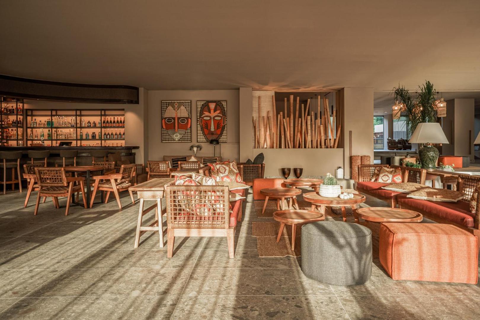 Cook's Club Corfu bāra zona ar koka krēsliem, etniska stila dekorācijām un saules pielietu atpūtas telpu