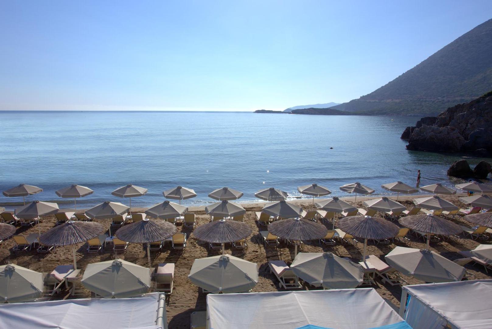 Bali Star Resort Hotel pludmales zona no augšas — sakārtotas rindas ar saulessargiem un zviļņiem pie dzidra jūras krasta