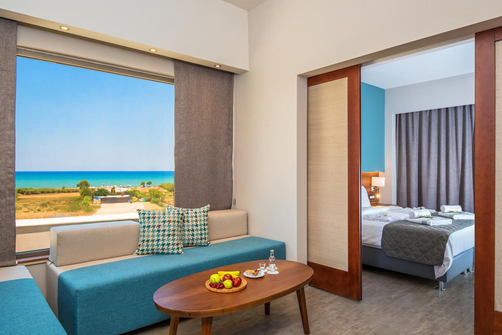 Solimar Aquamarine Resort ģimenes numurs ar atsevišķu guļamistabu, dzīvojamo zonu un lielu logu ar skatu uz jūru