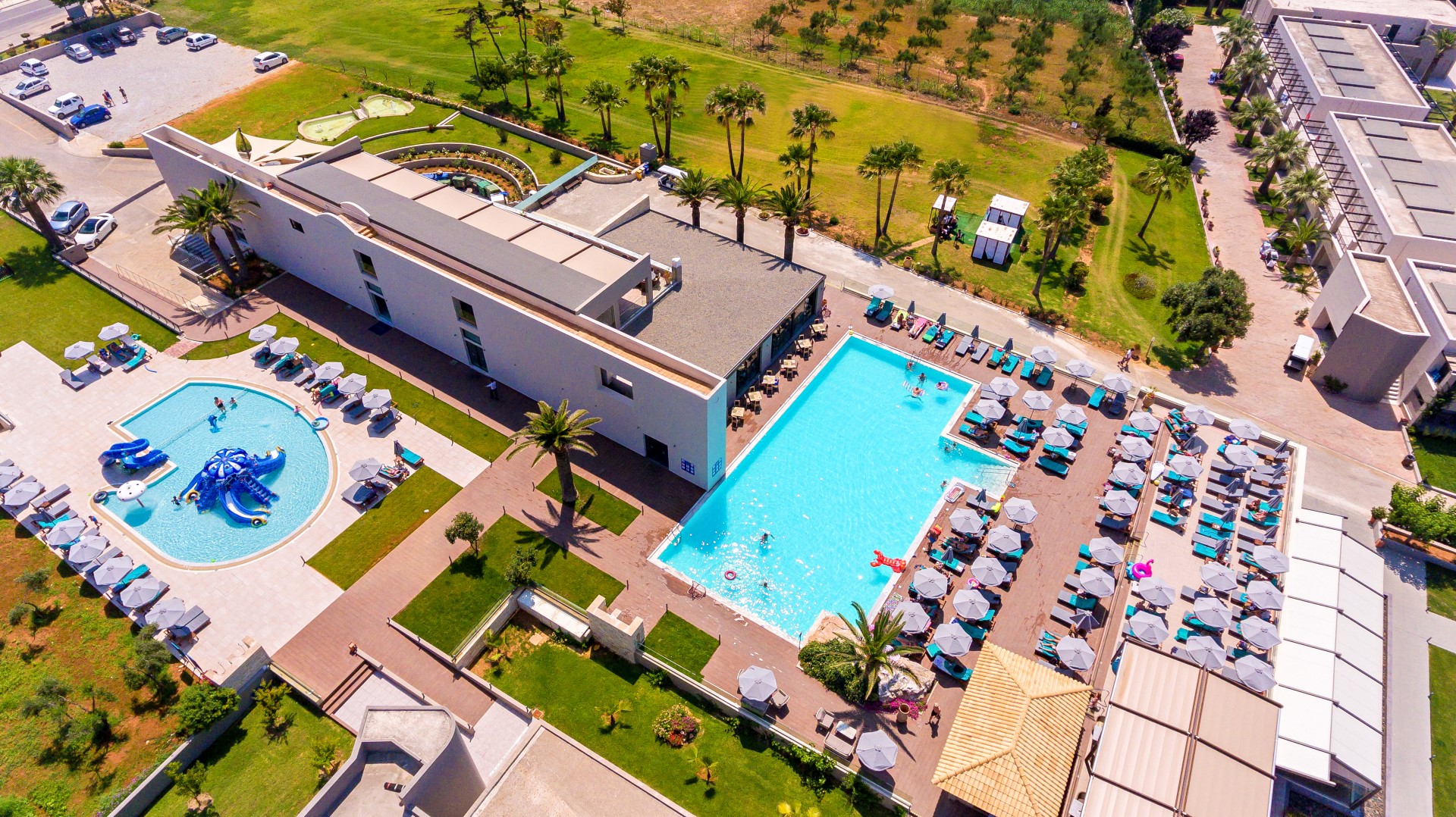 Solimar Aquamarine Resort teritorijas skats no putna lidojuma ar baseiniem, bērnu ūdens atrakcijām un viesnīcas korpusiem zaļā apkārtnē