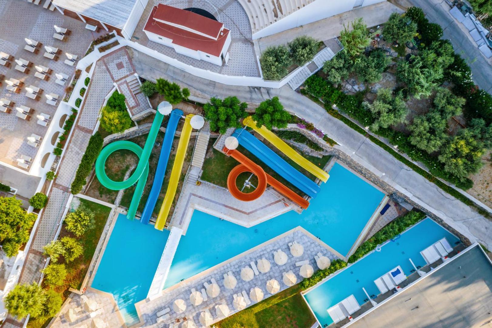 Lindos Royal Resort akvaparks no putna lidojuma — krāsaini ūdens slidkalniņi un peldbaseini bērnu un pieaugušo izklaidei