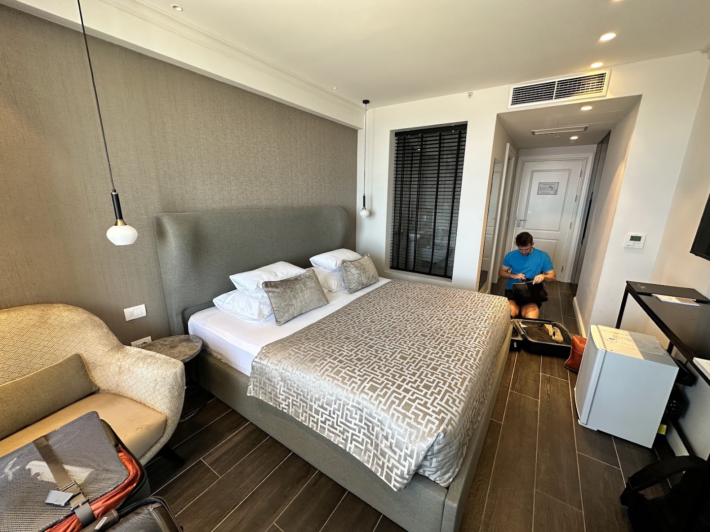 Vivid Blue Serenity Hotel mājīgs viesnīcas numurs ar lielu gultu, modernu apgaismojumu un neitrālu krāsu interjeru
