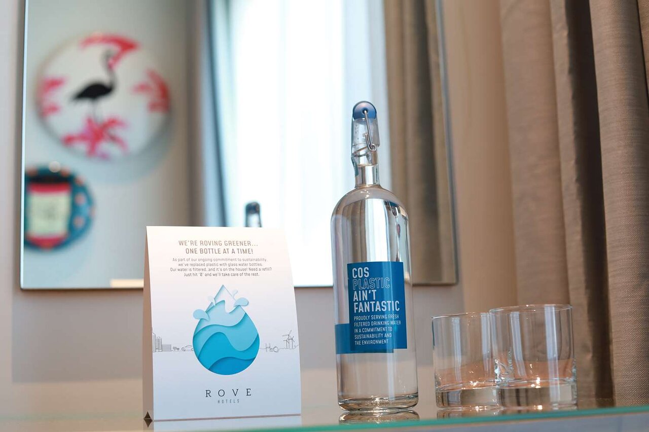 Rove Dubai Marina's eco-friendly glass water bottle and note.